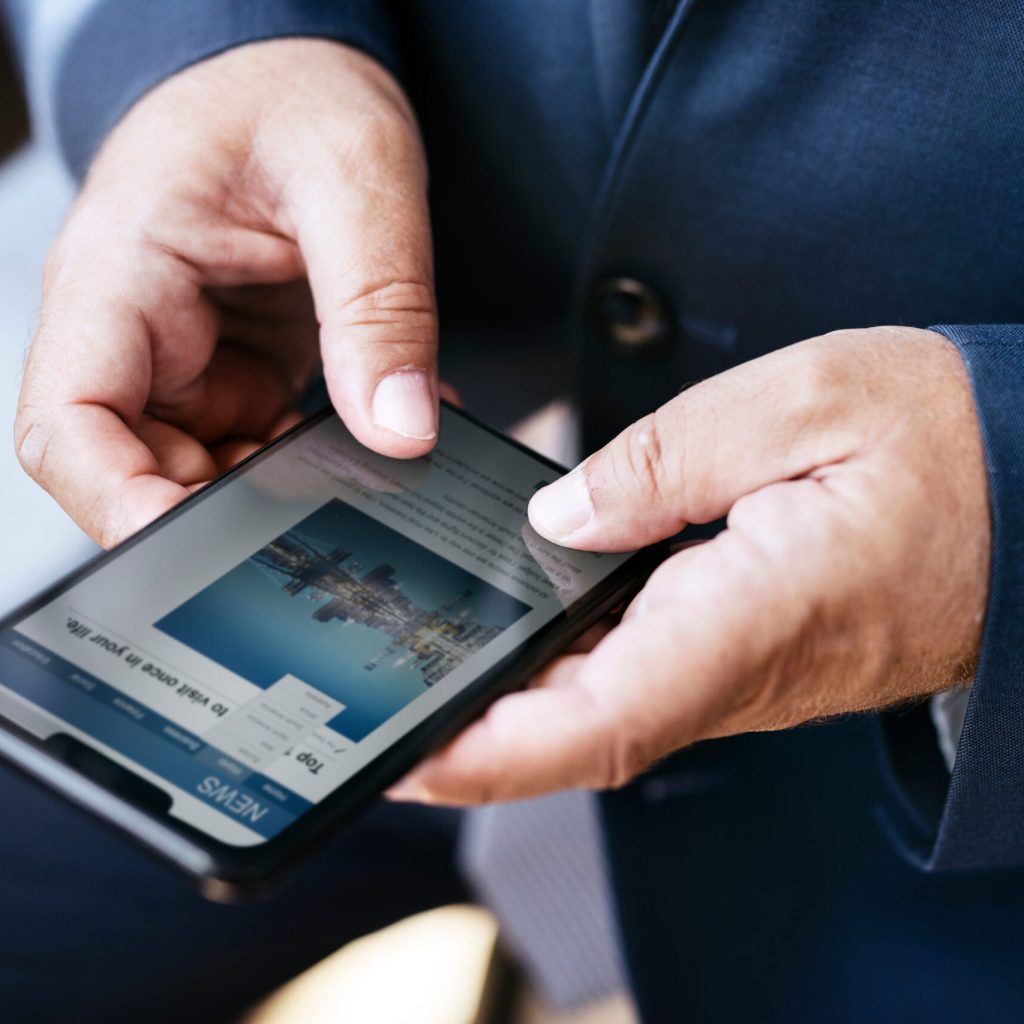 Hands using smartphone reading news on screen